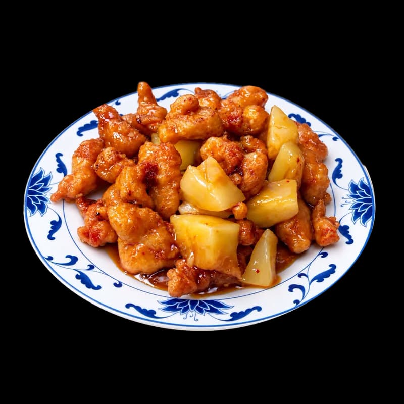 Pineapple chicken with chunks of pineapple on a blue and white plate